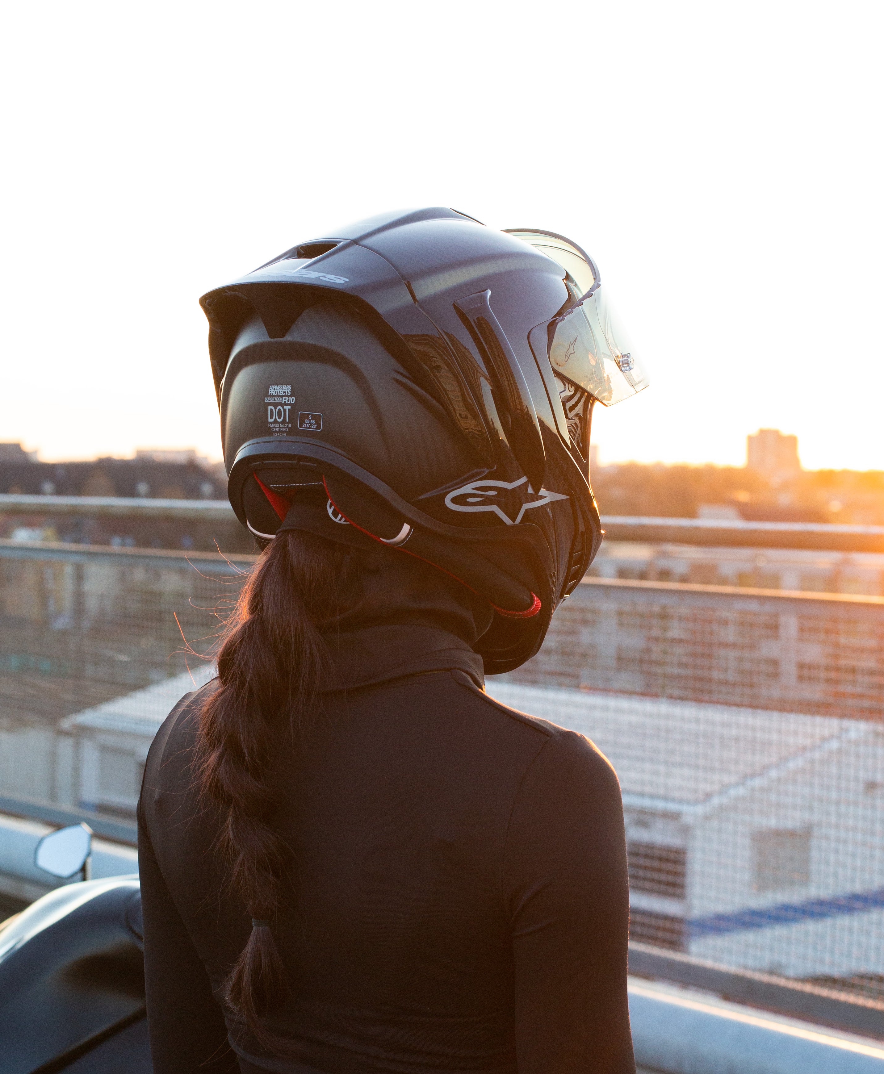 Female rider wearing BRAIDFIT BALACLAVA under motorcycle helmet