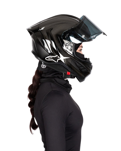 Side view of female rider wearing BRAIDFIT BALACLAVA and motorcycle helmet